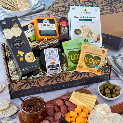 Deluxe meat and cheese sampler with artisan sausages, cheeses, crackers and tomato bruschetta